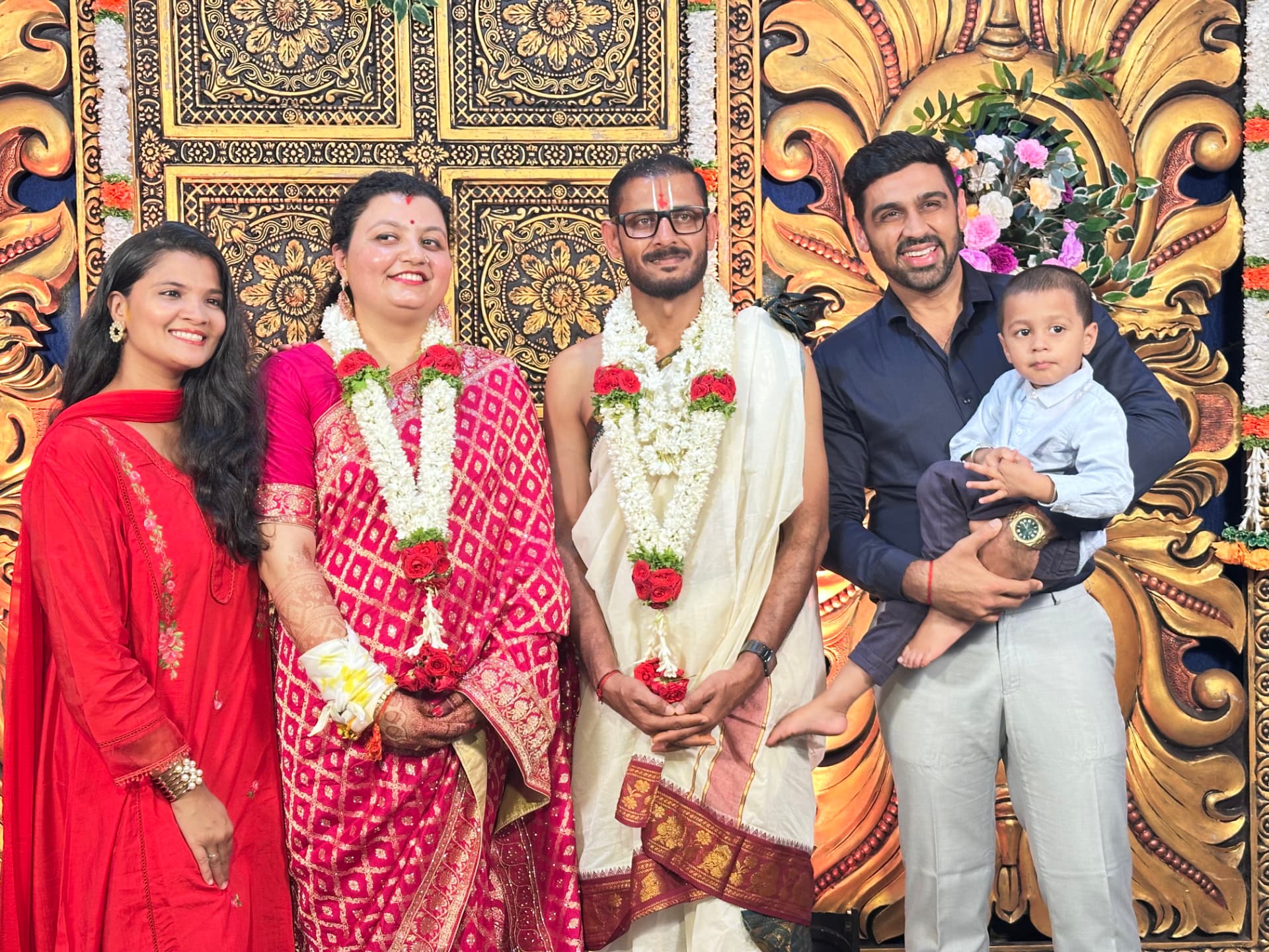 Anshul celebrating with a newlywed couple and family
